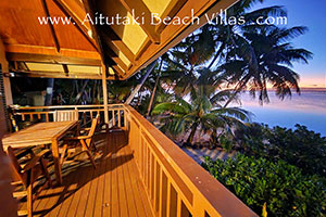 sunset from the veranda of the beach villa over aitutaki lagoon